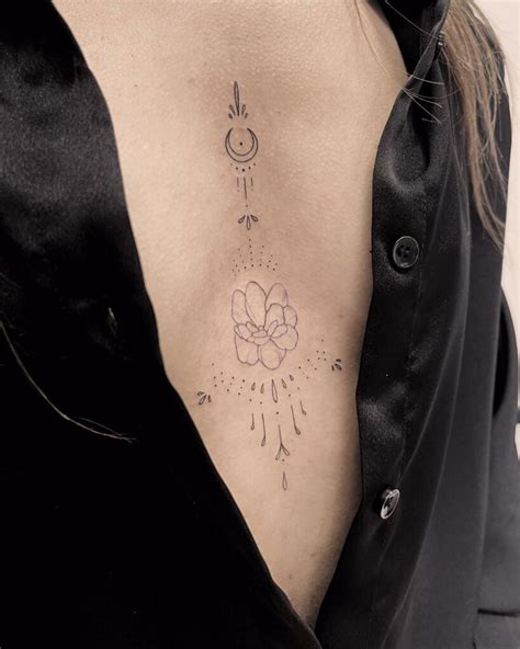 sternum between breast tattoos|Tattoo between breast